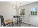 Cozy dining area with modern table and chairs near window and door at 7169 Sweet Gum Ct, Lithonia, GA 30058