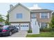 Charming two-story home with brick and vinyl siding, attached garage, and well-maintained front yard at 7169 Sweet Gum Ct, Lithonia, GA 30058