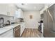 Modern kitchen features granite countertops, stainless steel appliances, and white cabinetry at 7169 Sweet Gum Ct, Lithonia, GA 30058