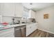 Modern kitchen features granite countertops, stainless steel appliances, and white cabinetry at 7169 Sweet Gum Ct, Lithonia, GA 30058