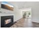 Living room features a fireplace, luxury vinyl floors, and window bringing in natural light at 7169 Sweet Gum Ct, Lithonia, GA 30058