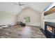 Spacious living room with vaulted ceiling, fireplace, and large window at 7169 Sweet Gum Ct, Lithonia, GA 30058