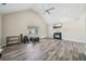 Spacious living room with vaulted ceiling, fireplace, and large window at 7169 Sweet Gum Ct, Lithonia, GA 30058