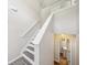 Bright staircase featuring neutral walls, modern railing, and access to the upper level at 7169 Sweet Gum Ct, Lithonia, GA 30058
