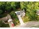Aerial shot of home featuring a pool, mature trees, and well-manicured lawn at 1020 Travitine Trl, Loganville, GA 30052