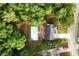 Overhead view of the house highlighting the pool, patio, and tree-lined property at 1020 Travitine Trl, Loganville, GA 30052