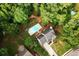 Aerial view of the home featuring a large in-ground pool and sprawling wooded lot at 1020 Travitine Trl, Loganville, GA 30052