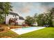 Inviting backyard features an in-ground pool, deck and lounging area, surrounded by mature trees at 1020 Travitine Trl, Loganville, GA 30052