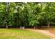 Lush backyard with mature trees offers an incredible space for entertainment and recreation at 1020 Travitine Trl, Loganville, GA 30052