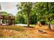 Large backyard offers a variety of entertainment options with a pool, deck, play set, and fire pit at 1020 Travitine Trl, Loganville, GA 30052