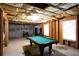 Partially finished basement with a pool table, perfect for creating a recreation or entertainment area at 1020 Travitine Trl, Loganville, GA 30052