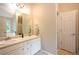 Well-lit bathroom with double sinks, spacious countertop, and tile flooring at 1020 Travitine Trl, Loganville, GA 30052
