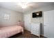 Comfortable bedroom with a ceiling fan, TV, and a view at 1020 Travitine Trl, Loganville, GA 30052