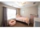 Charming bedroom with a cozy bed, a soft color scheme, and a window at 1020 Travitine Trl, Loganville, GA 30052