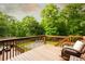 Relaxing deck area with comfortable seating, perfect for enjoying the serene wooded surroundings at 1020 Travitine Trl, Loganville, GA 30052