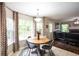 Bright dining area with large windows, modern lighting, and views into the living room at 1020 Travitine Trl, Loganville, GA 30052