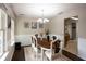 Dining room showcases natural light, a dark wood table with seating for six, and access to the kitchen at 1020 Travitine Trl, Loganville, GA 30052