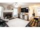 Inviting living room with stone fireplace, large TV, and access to other areas of the house at 1020 Travitine Trl, Loganville, GA 30052