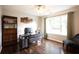 Well-lit home office with wood floors, a large window, and built-in shelving at 1020 Travitine Trl, Loganville, GA 30052