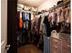 Well-organized walk-in closet filled with clothing and accessories, maximizing storage space at 1020 Travitine Trl, Loganville, GA 30052