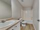 Bathroom featuring a walk-in shower, single sink vanity and wood-look floors at 10961 Big Sky Dr, Hampton, GA 30228
