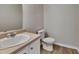 Bathroom featuring a single sink vanity, neutral walls and wood-look flooring at 10961 Big Sky Dr, Hampton, GA 30228
