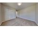 This bedroom features plush carpet, neutral walls and a double door closet at 10961 Big Sky Dr, Hampton, GA 30228