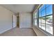 This bedroom features plush carpet, a double door closet and large windows for natural light at 10961 Big Sky Dr, Hampton, GA 30228