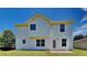 Back exterior view of the home featuring a patio, level lawn and plenty of sunshine at 10961 Big Sky Dr, Hampton, GA 30228