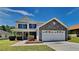 Charming two-story home featuring a stone facade, attached garage, and a well-maintained front yard at 10961 Big Sky Dr, Hampton, GA 30228