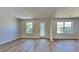 Bright living room showcasing new flooring and an exit leading to the outdoors at 10961 Big Sky Dr, Hampton, GA 30228