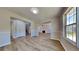 Bright living room with wood flooring, a fireplace, and natural light through a large window at 10961 Big Sky Dr, Hampton, GA 30228