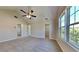 Bright main bedroom featuring a vaulted ceiling with fan, neutral walls, and large windows at 10961 Big Sky Dr, Hampton, GA 30228