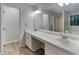 Bathroom featuring a double sink vanity, mirror and modern fixtures, with a tub in the background at 2352 Benson Rdg, Lithonia, GA 30058