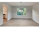 Dining room with wood-look floors, neutral paint, and natural light from a large window at 2352 Benson Rdg, Lithonia, GA 30058