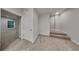 Bright hallway features neutral tones, plush carpeting, and a door with a window view at 2352 Benson Rdg, Lithonia, GA 30058
