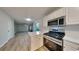 Open concept kitchen with stainless steel appliances, white cabinets and quartz countertops at 2352 Benson Rdg, Lithonia, GA 30058