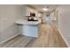 Modern kitchen features stainless steel appliances, an island with seating, and wood-look floors at 2352 Benson Rdg, Lithonia, GA 30058