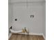 A simple laundry room with laminate floors, white walls, and wire rack shelving at 2352 Benson Rdg, Lithonia, GA 30058