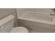 Clean bathroom with toilet and bright white tub at 3066 Reserve Ct Sw, Conyers, GA 30094