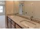 Bathroom featuring double granite vanity with modern faucets and large mirror at 3066 Reserve Ct Sw, Conyers, GA 30094