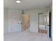 Bright bedroom with neutral carpet, walls, trim, and views into the hallway and closet at 3066 Reserve Ct Sw, Conyers, GA 30094