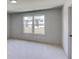 Sunlit bedroom with a large window providing great neighborhood views, creating a serene and inviting atmosphere at 3066 Reserve Ct Sw, Conyers, GA 30094