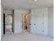Bedroom featuring neutral carpet, walls, trim, and views into the hallway and closet at 3066 Reserve Ct Sw, Conyers, GA 30094