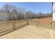 Large wooden deck with wooden railing with an open forest view at 3066 Reserve Ct Sw, Conyers, GA 30094