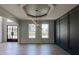 Elegant dining room with hardwood floors, modern light fixture, black wall trim and glass paneled door at 3066 Reserve Ct Sw, Conyers, GA 30094