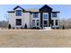 Charming two-story home with black trim accents, landscaped yard, and manicured lawn at 3066 Reserve Ct Sw, Conyers, GA 30094