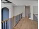 Open hallway featuring wood floors and stylish railings, providing an inviting transition between spaces at 3066 Reserve Ct Sw, Conyers, GA 30094