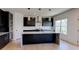 Modern kitchen with stainless steel appliances, granite counters, dark cabinetry, and light hardwood floors at 3066 Reserve Ct Sw, Conyers, GA 30094