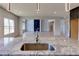 Kitchen island with granite counter overlooks open-concept living space at 3066 Reserve Ct Sw, Conyers, GA 30094